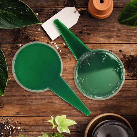 Easy Garden Seeder on wooden table with gardening tools and plants.