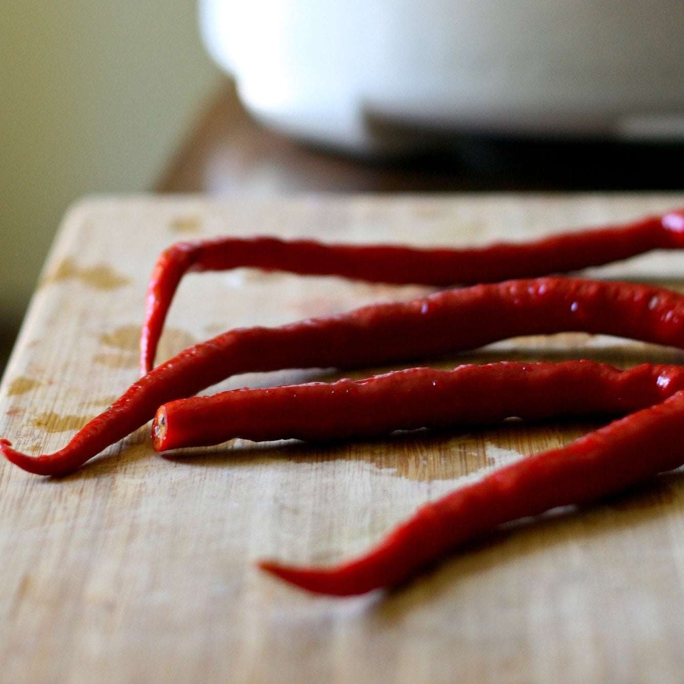 Hot Long Red Cayenne Pepper NT on wooden surface.