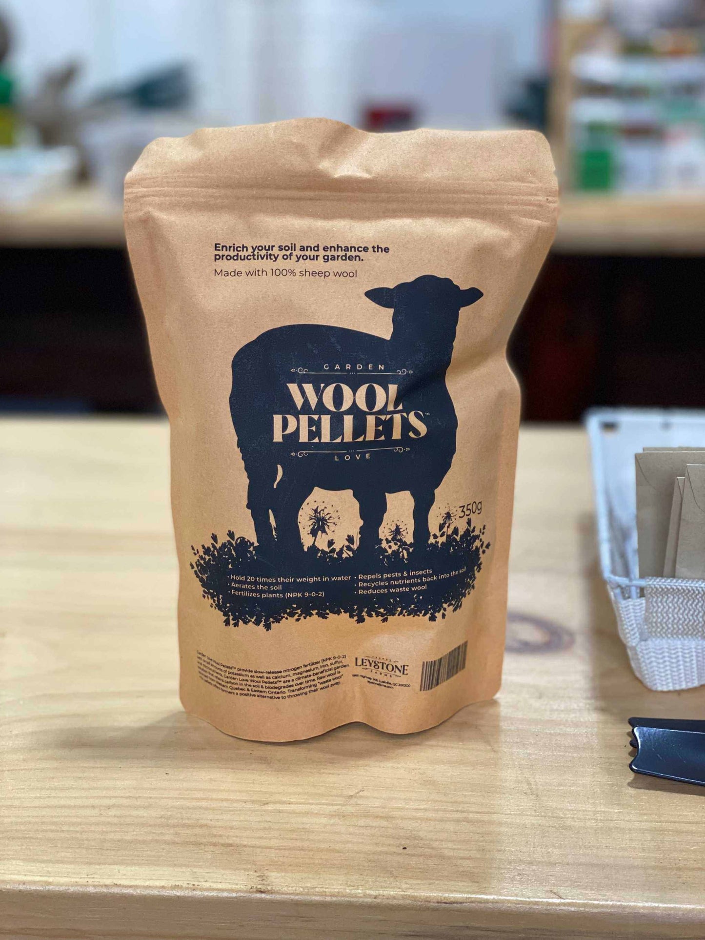 Wool Pellets by Leystone Farms in eco-friendly packaging on a wooden surface.