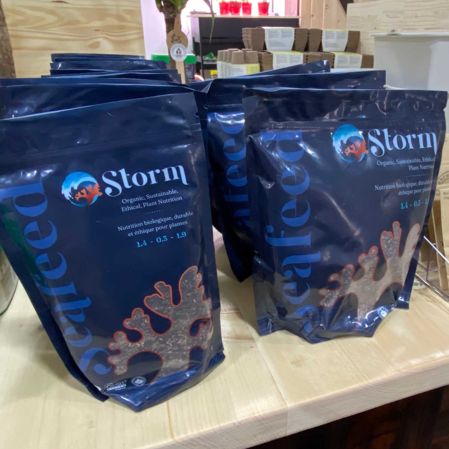 Storm Kelp Meal Organic Fertilizer bags on a wooden shelf, featuring Seafeed Plant Formulation label.