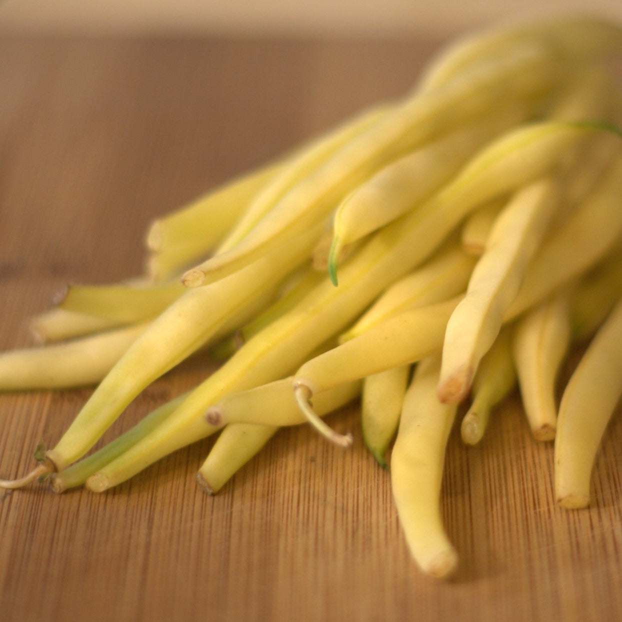 Goldilocks Yellow Bush Beans on wooden surface.