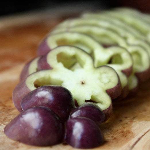 Sliced Purple Beauty Sweet Pepper showing vibrant purple and green hues.