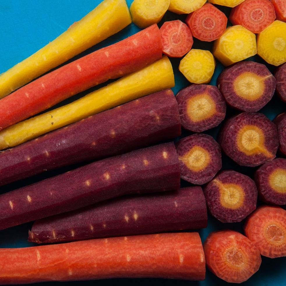 Rainbow Blend Carrot variety showcasing vibrant purple, white, red, and orange carrots.
