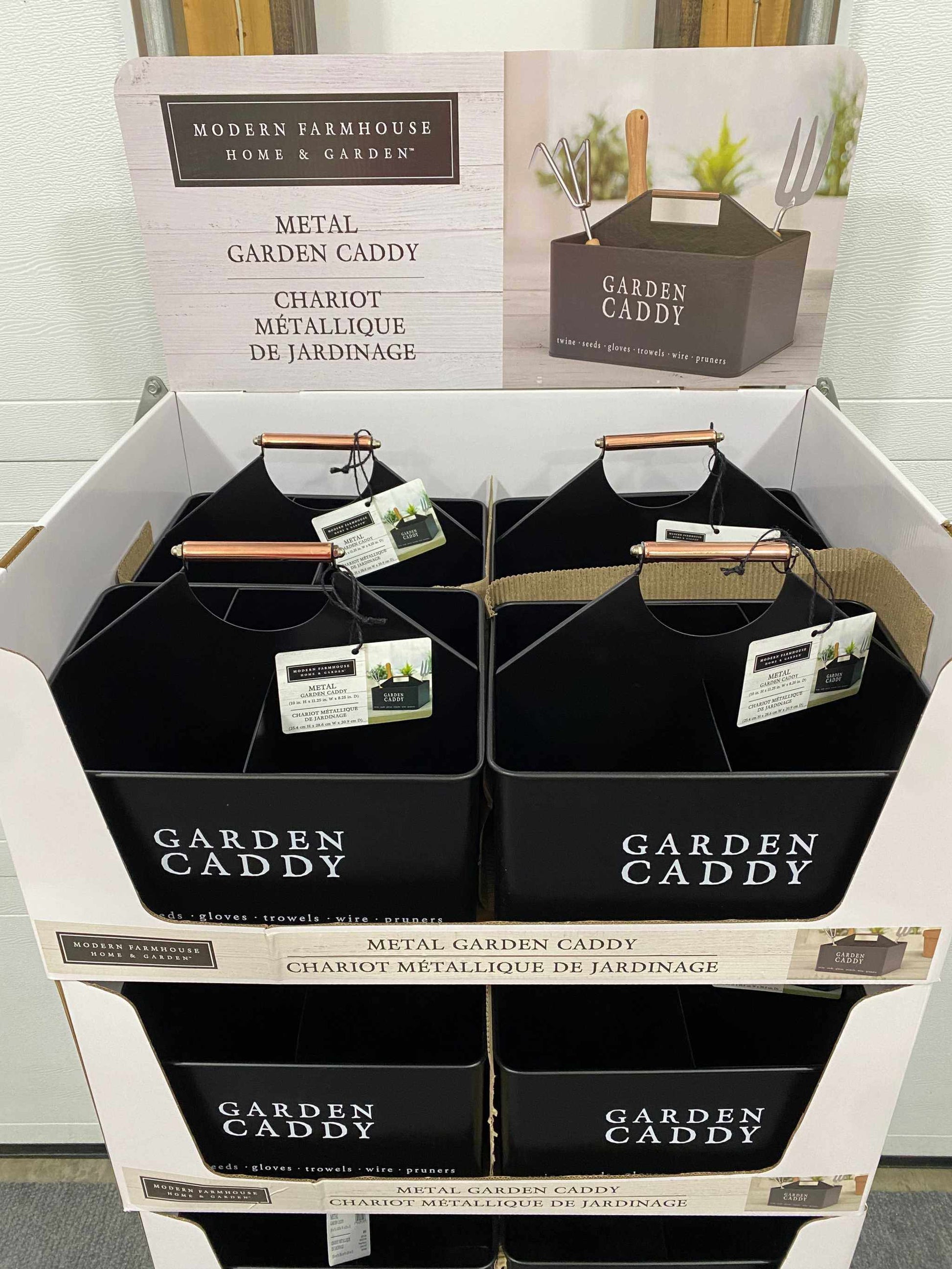 Decorative black metal garden caddy with handle, perfect for organizing tools and gardening supplies.