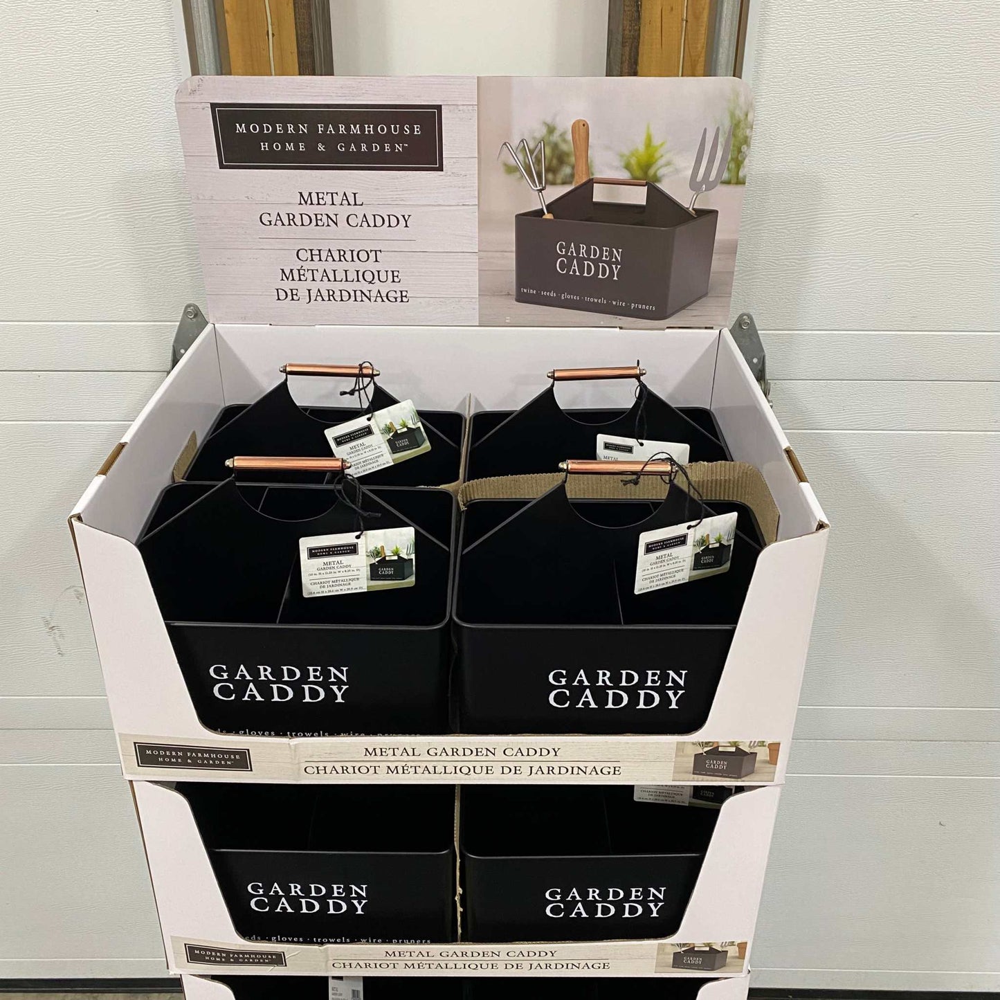 Decorative black metal garden caddy with sturdy top handle, ideal for organizing tools and gardening supplies, displayed in packaging.