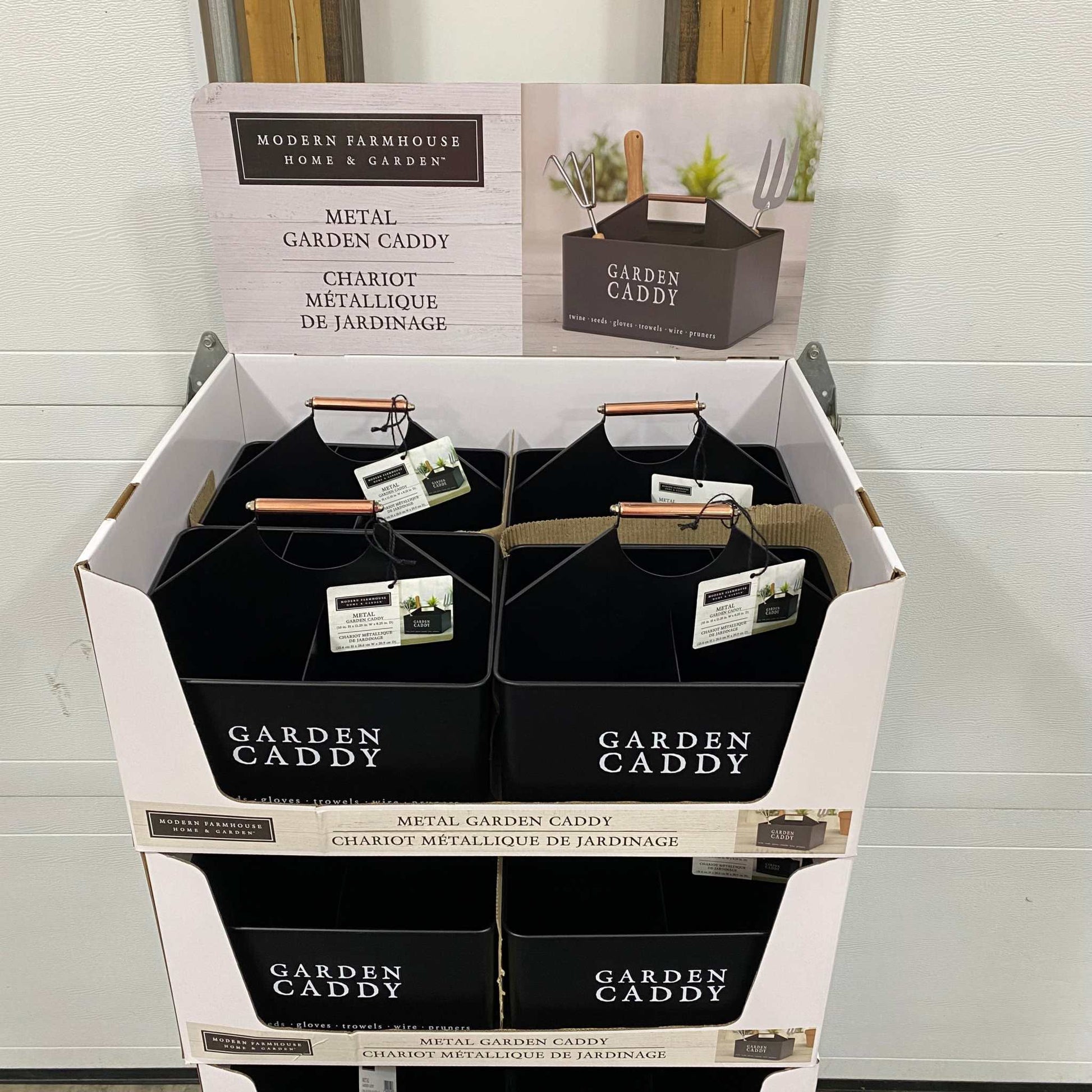 Decorative black metal garden caddy with sturdy top handle, ideal for organizing tools and gardening supplies, displayed in packaging.