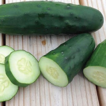 Marketmore 76 Cucumbers sliced on a wooden surface, showcasing dark green skin and crisp texture.